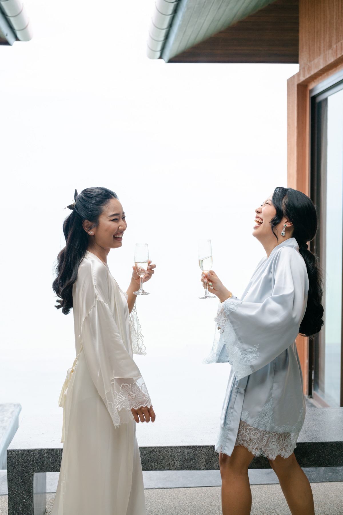 bride getting ready with bridesmaids in satin robe