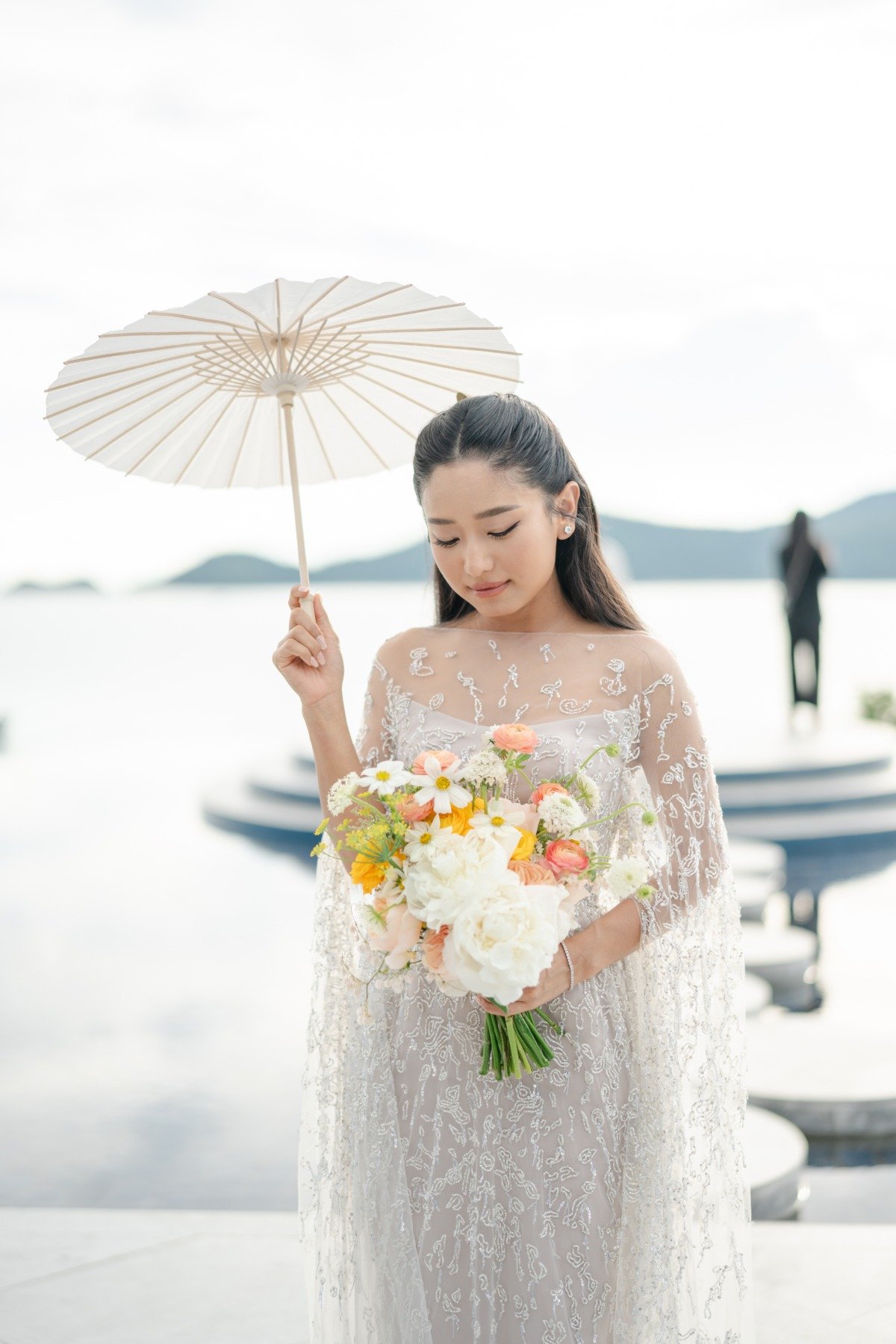 bride in beaded gown with parisol