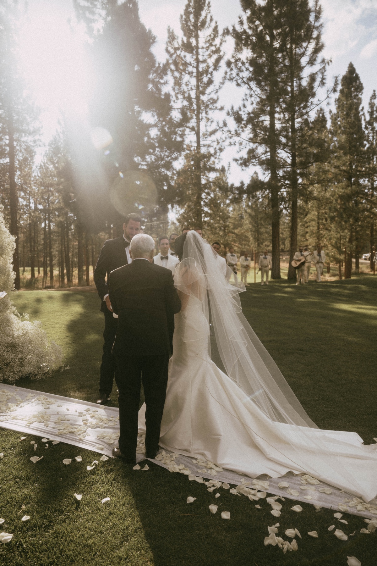 father walking bride down the aisle in the woods