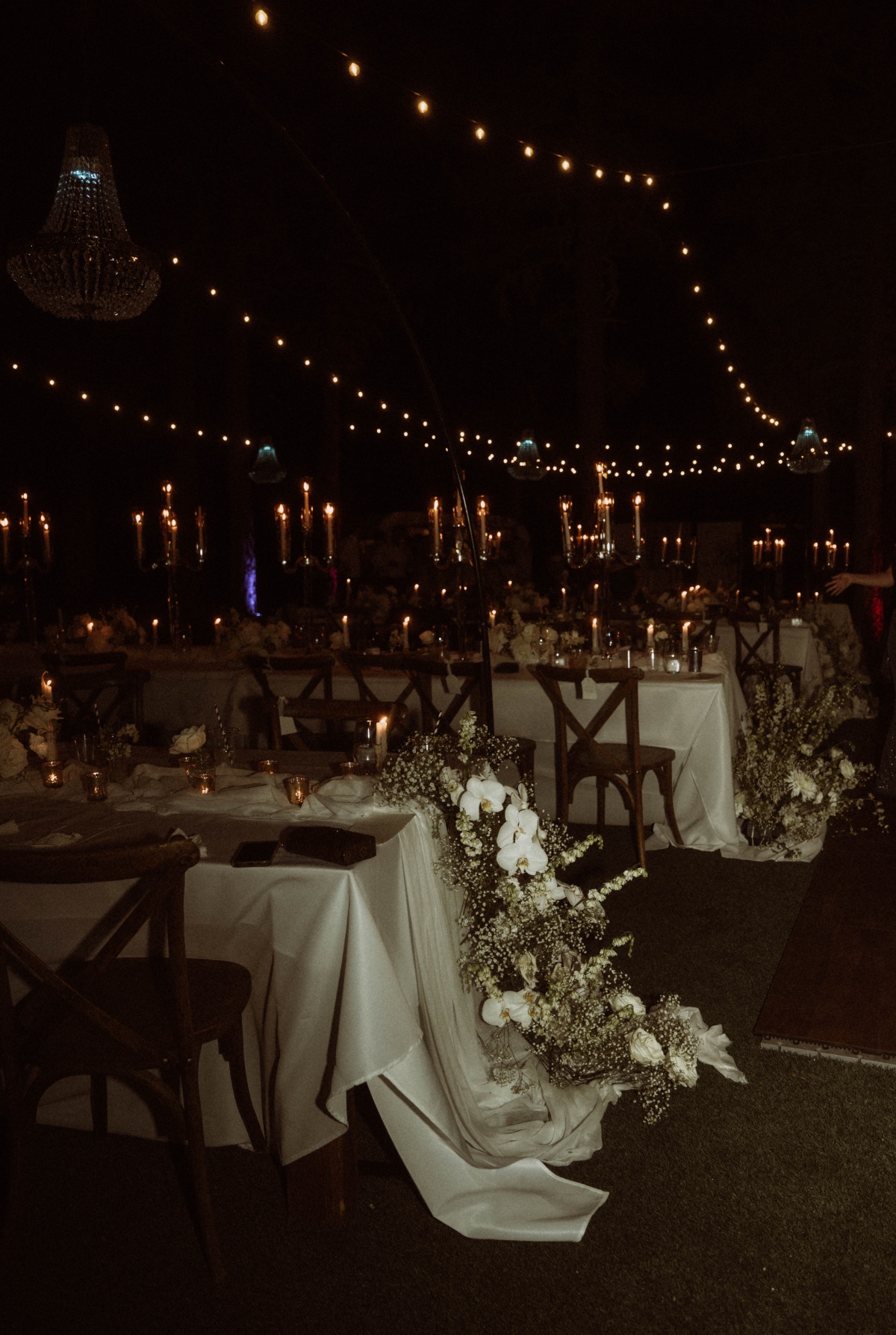 moody neutral outdoor wedding at night with twinkle lights