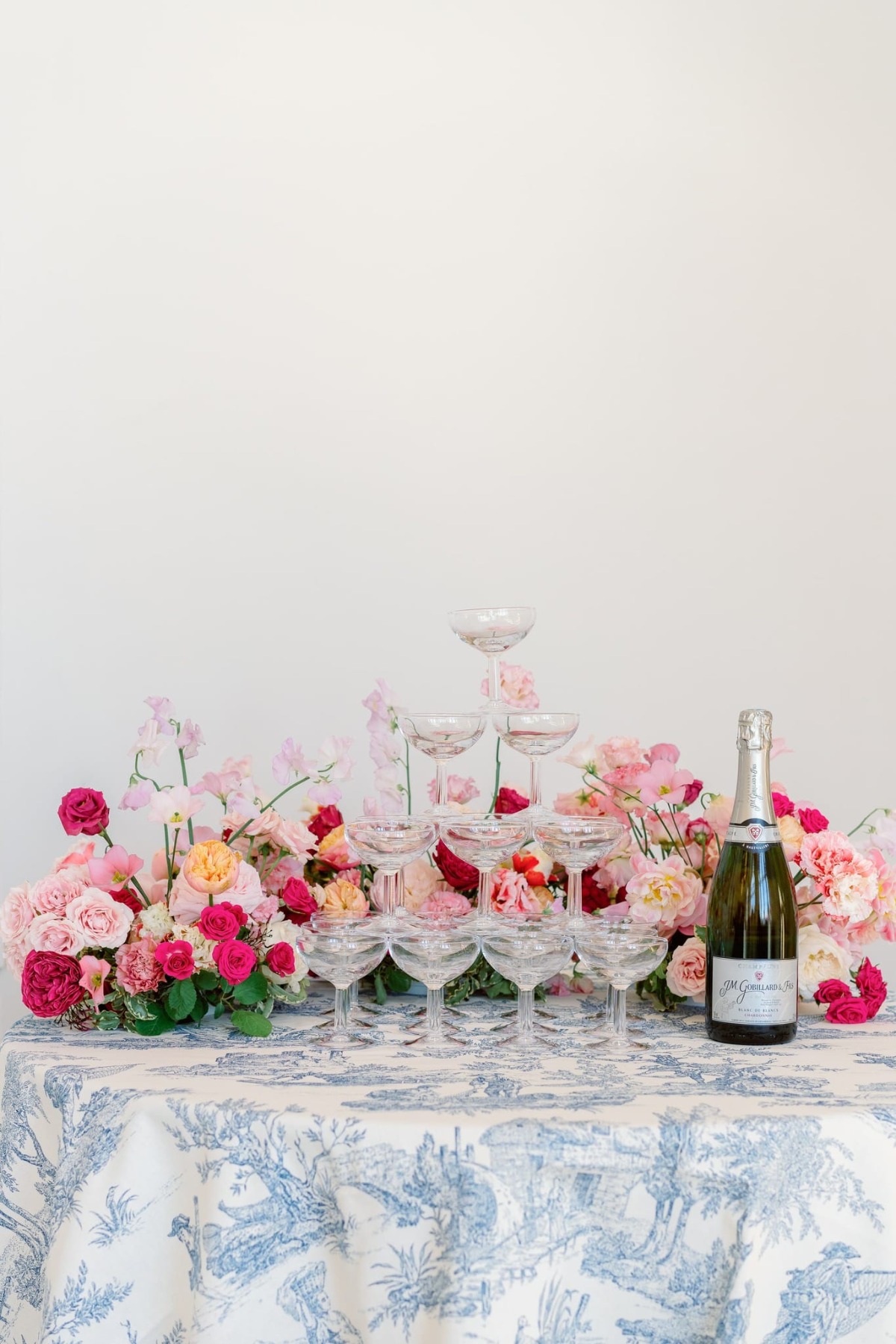 champagne tower table for wedding with pink flowers