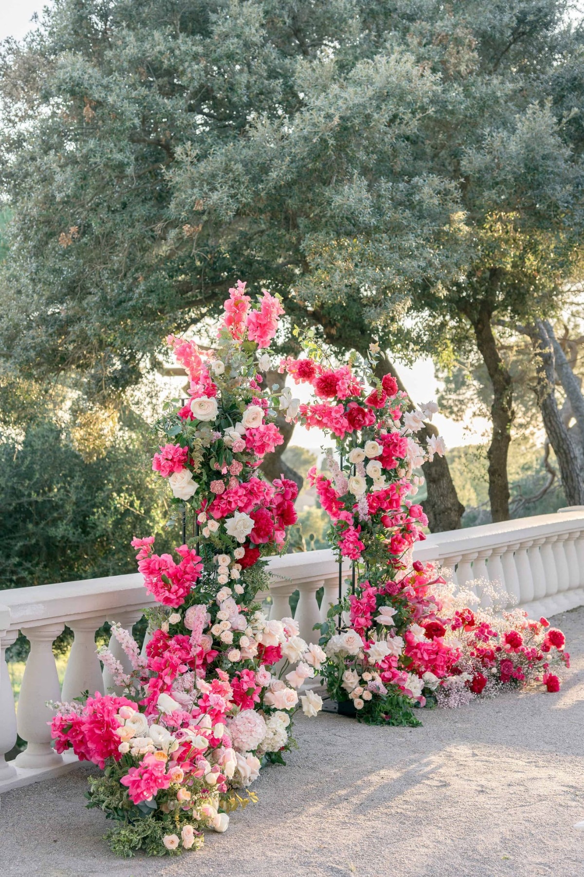 pink red and fuchsia wedding ceremony arch