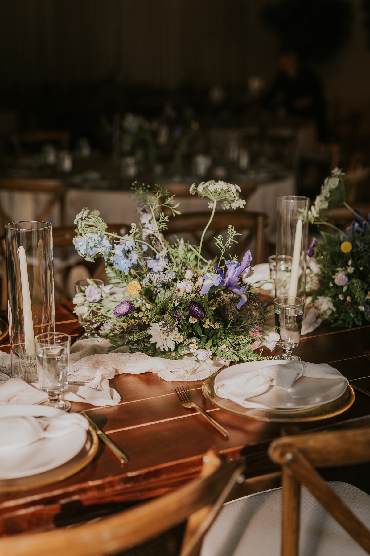 wildflower and iris centerpieces on cheesecloth tablerunners