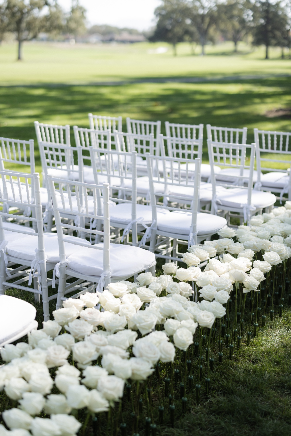 modern white rose wedding ceremony arrangements