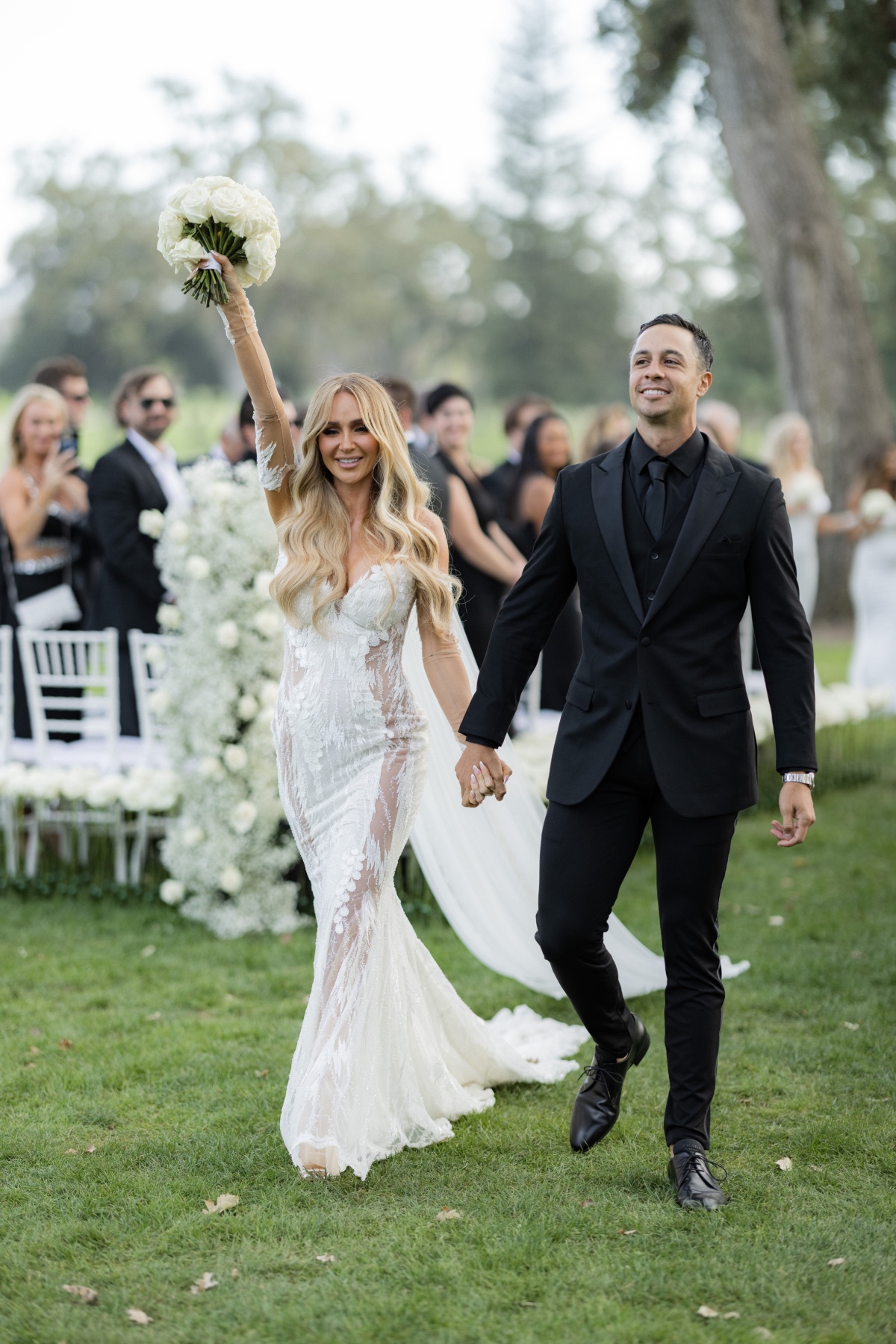 bride in sexy wedding dress and groom in all black