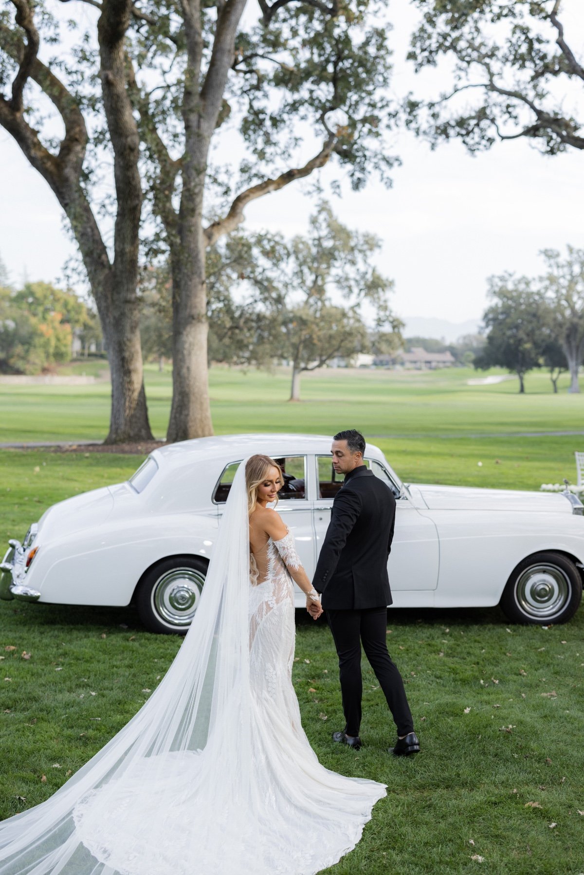 bride and groom get in vintage car at wedding