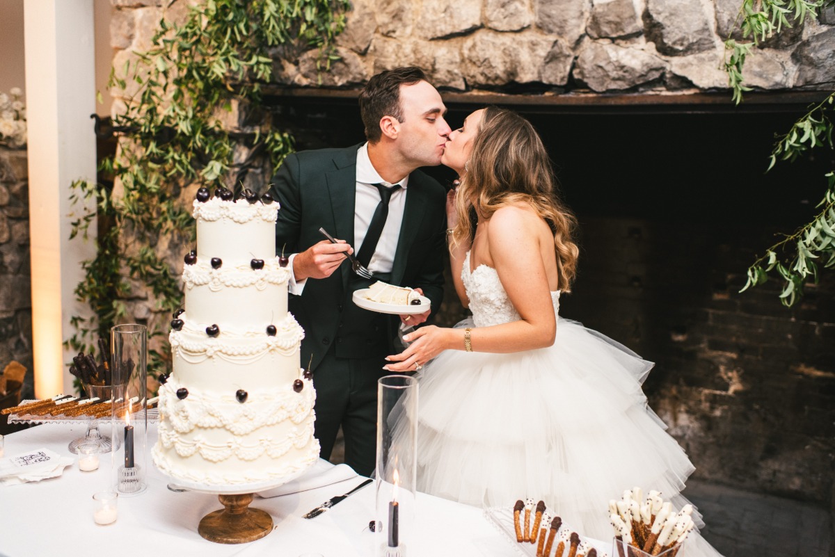 four tier white wedding cake with black accents