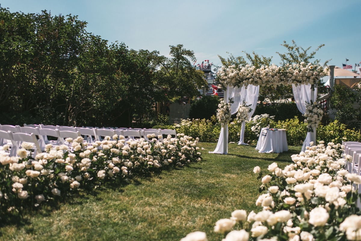 white rose lined ceremony aisle