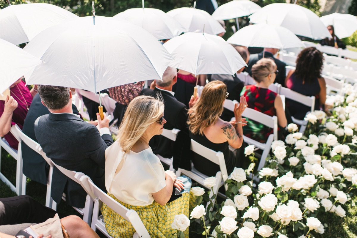 white umbrellas for outdoor wedding ceremony