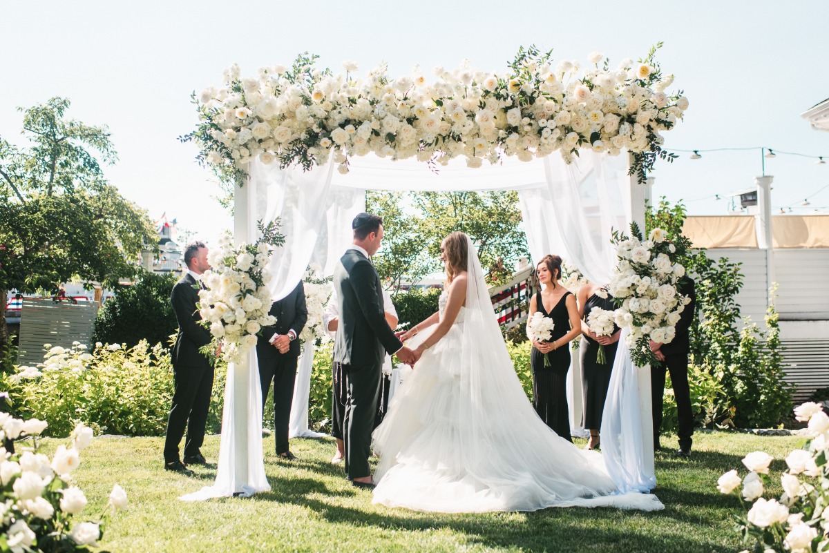 white rose and white drapery chuppah