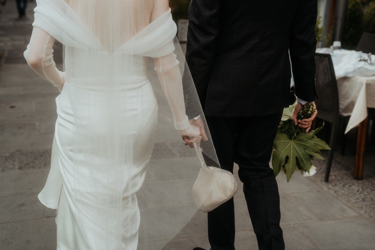 bride in off the shoulder pleated sleeve wedding gown