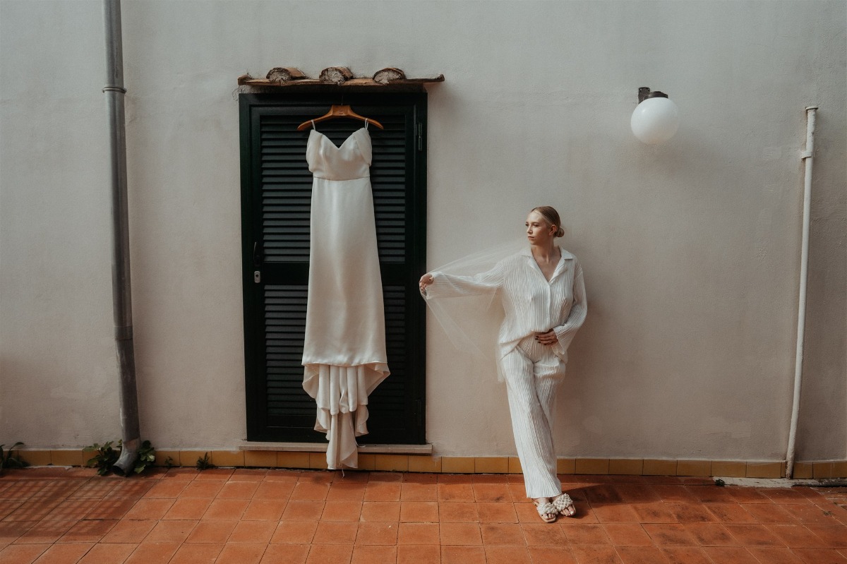 bride posing at italian apartment with wedding gown