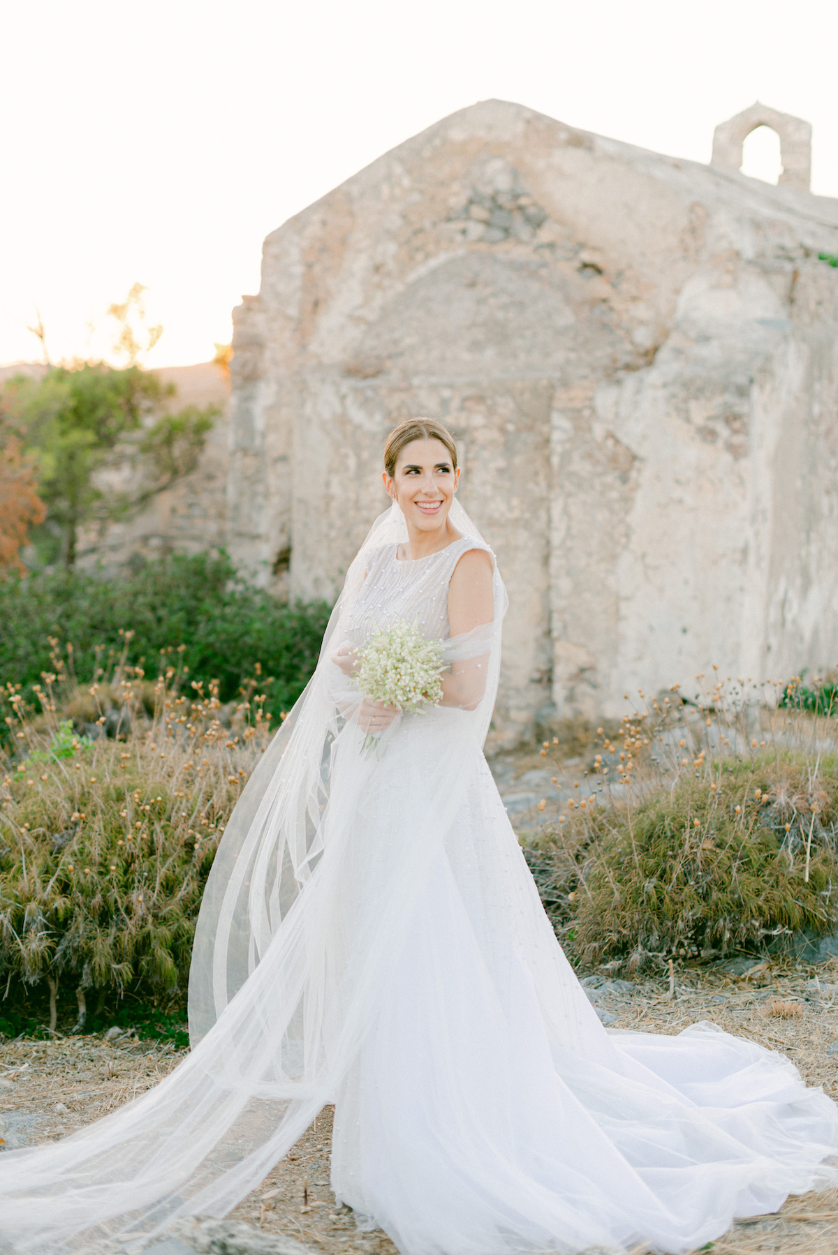 bride on greek island posing by ancient church