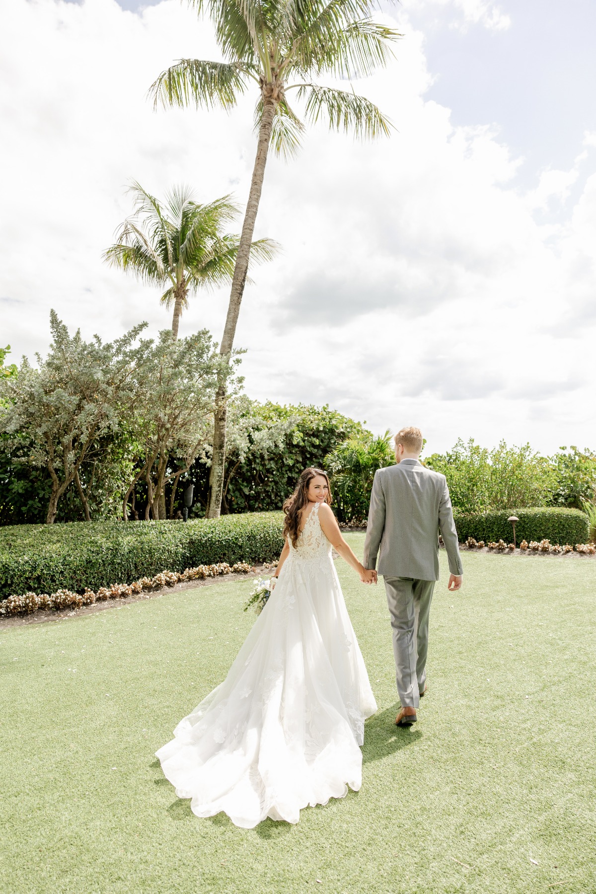 bride and groom walking in garden at florida wedding