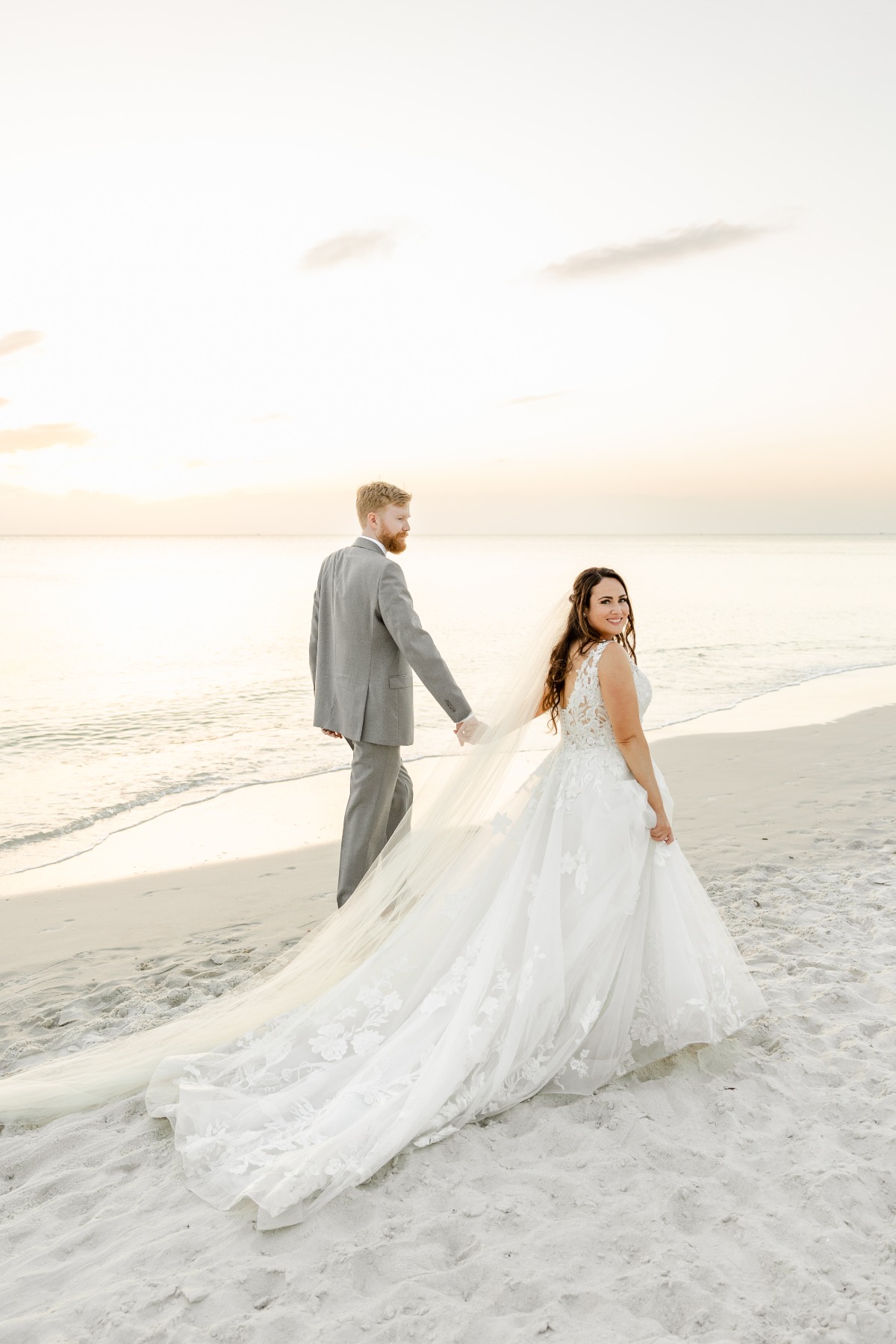 bride and groom walk on the beach in naples florida