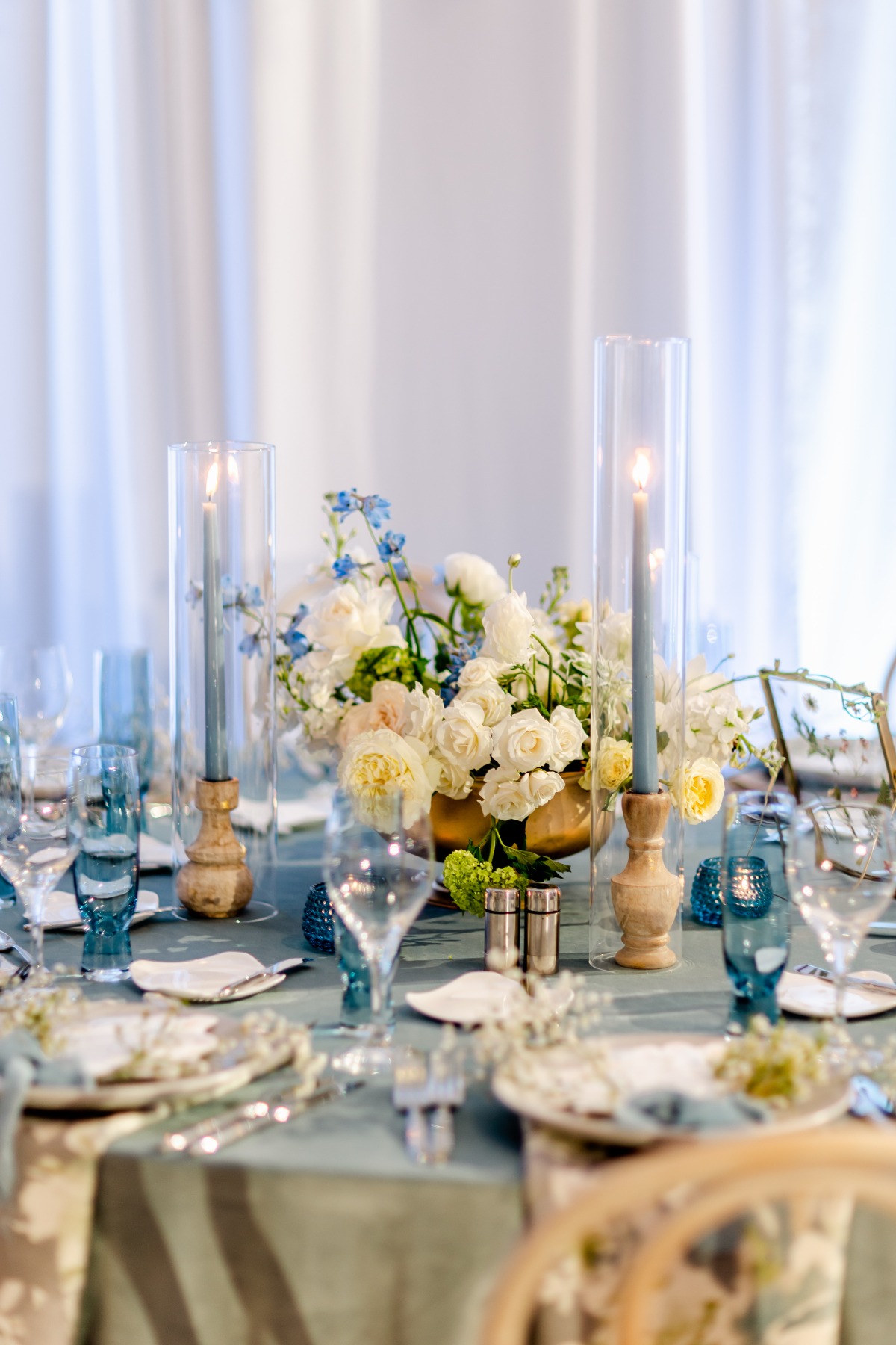 blue and white wedding table design for reception with candles