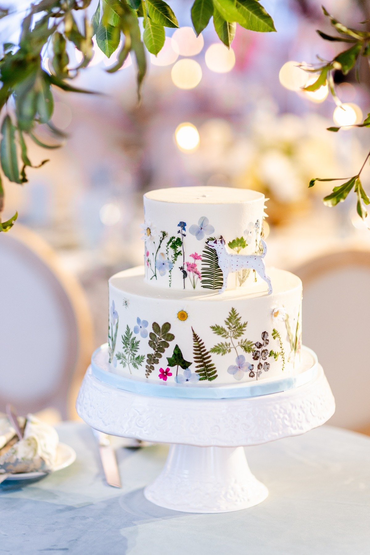 pressed flower wedding cake with dog topper