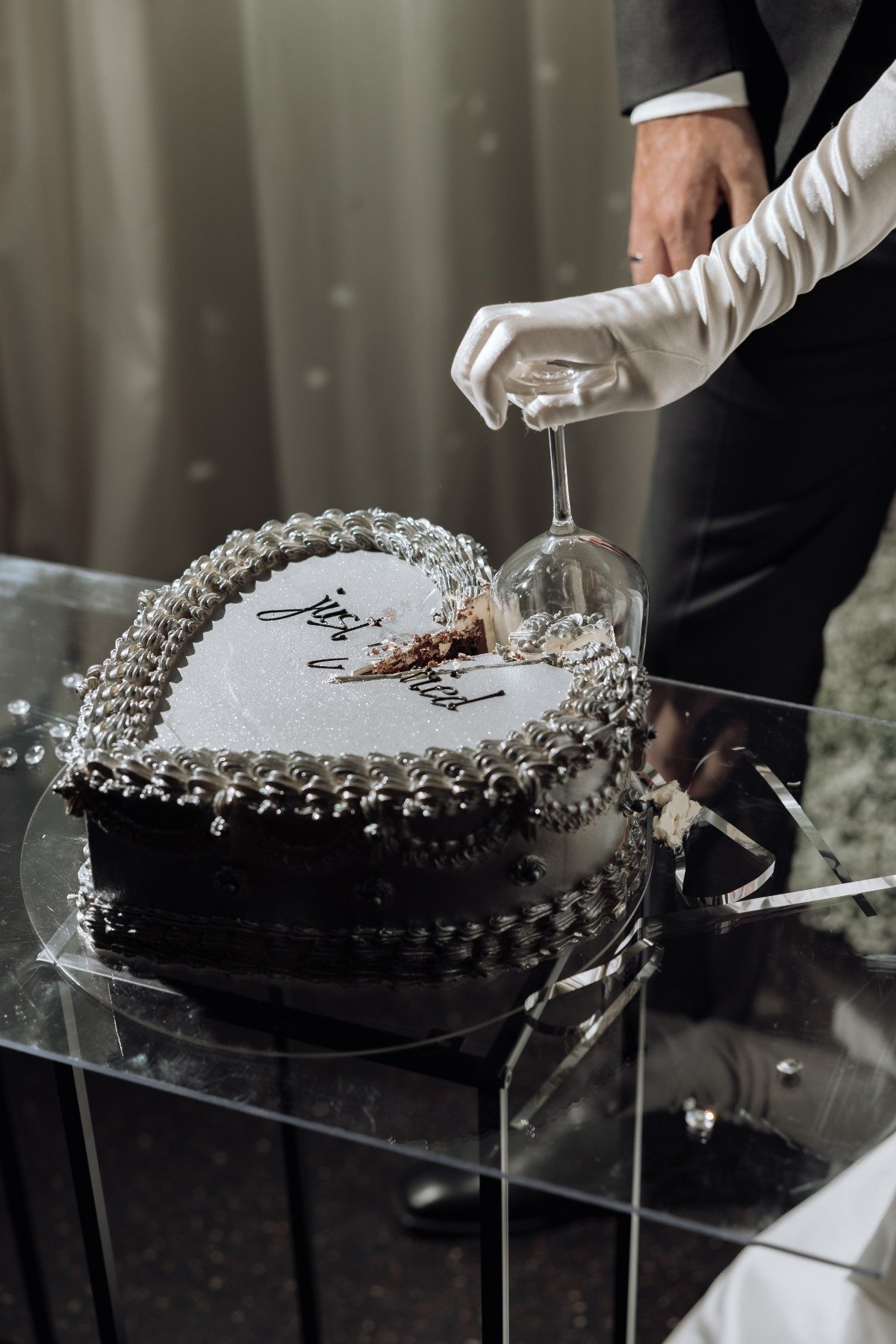 cutting cake with a wine glass