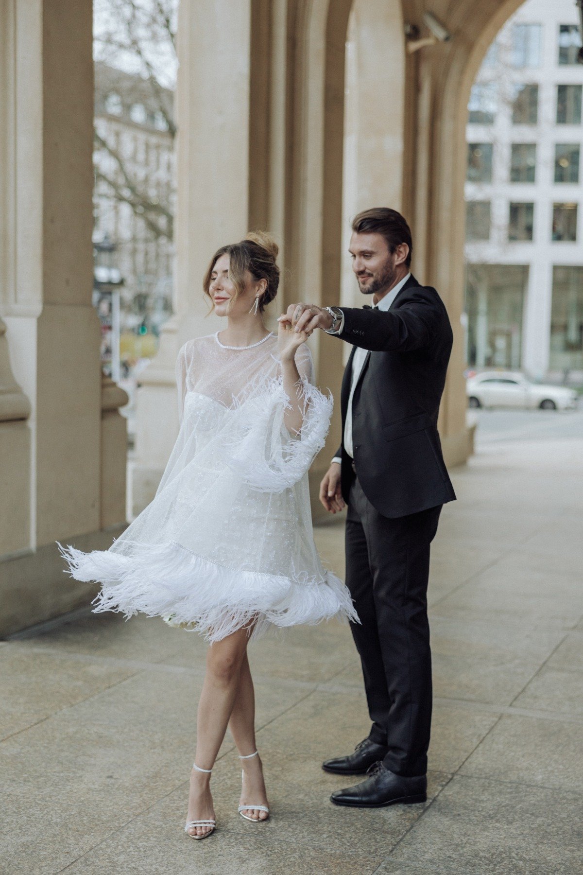 bride in a feathered mini dress