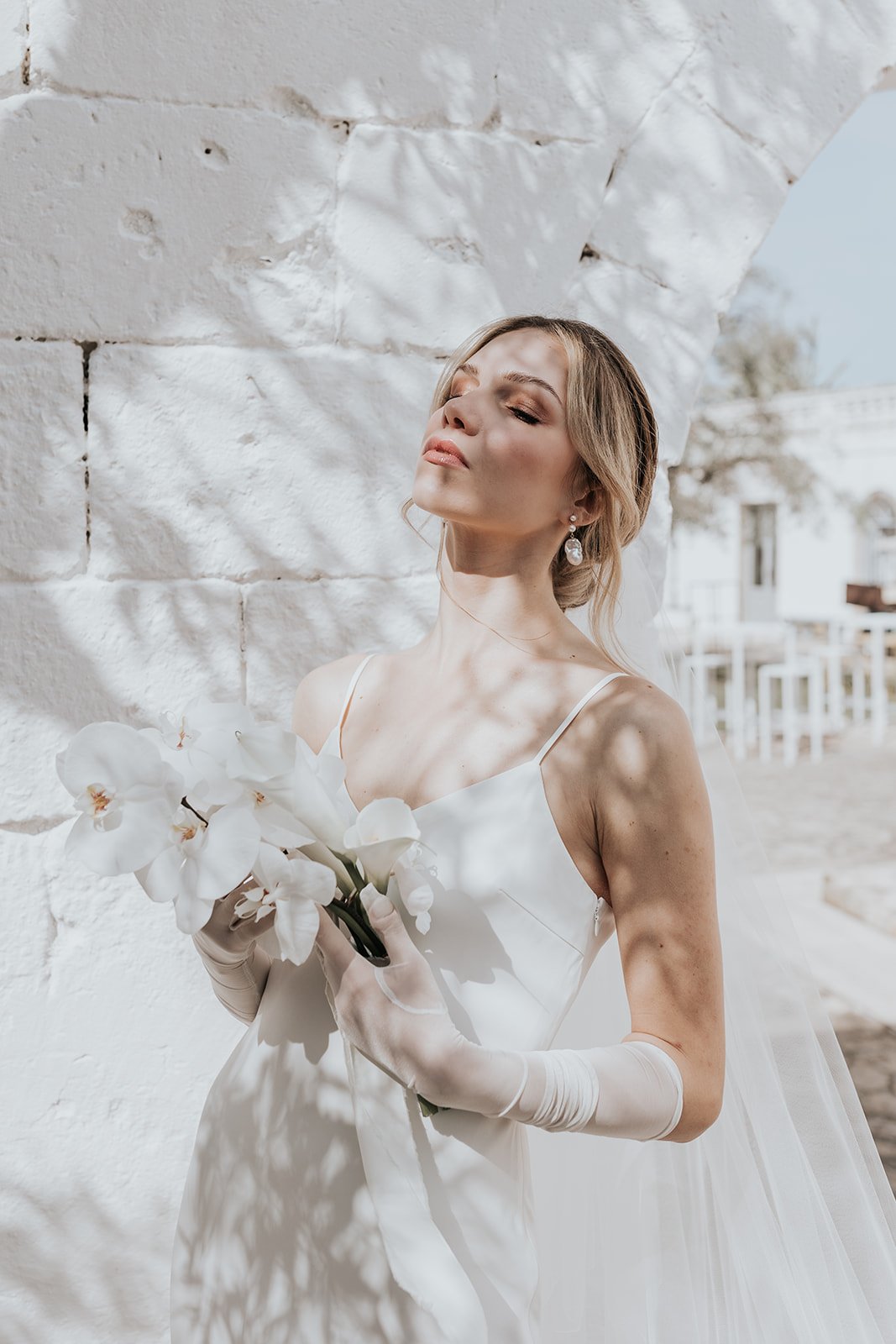 bride in minimalist wedding dress with sheer white gloves 