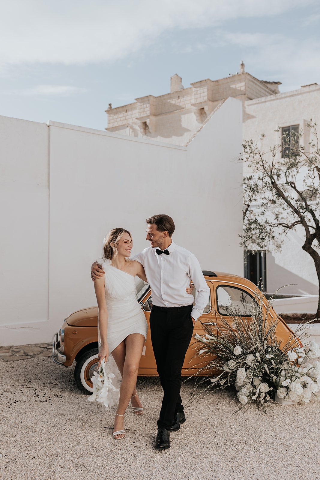 bride in one shoulder white mini dress