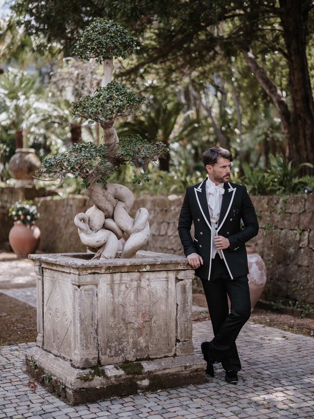 groom in ornate black and white tuxedo