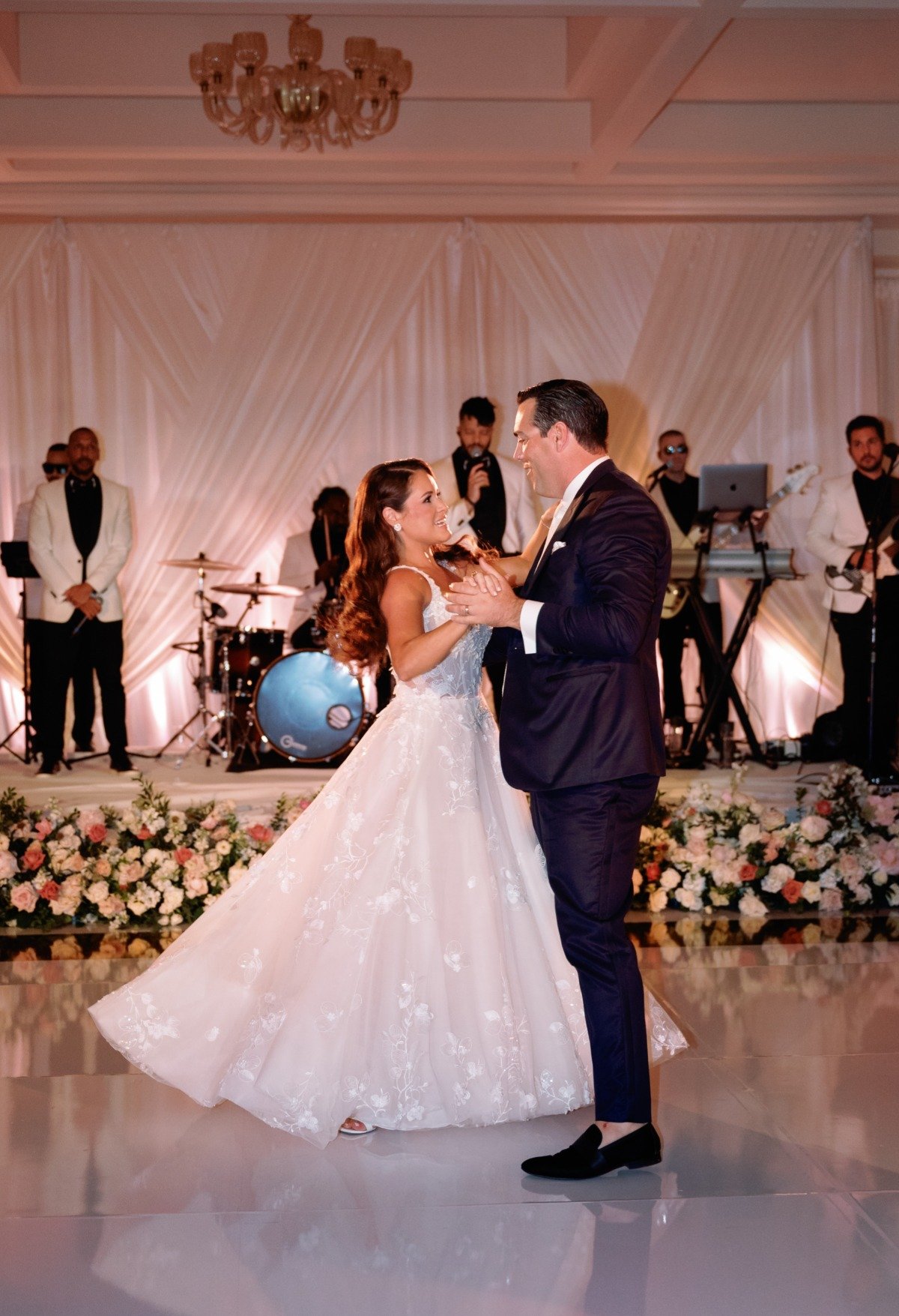 bride and groom dancing with live band