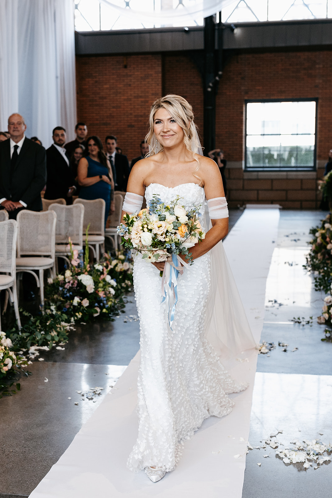 bride in 3d flower gown walking down the aisle