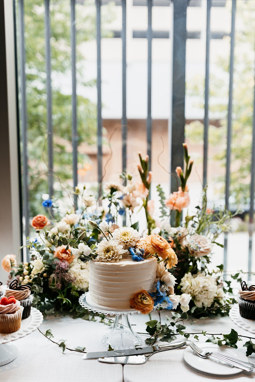 simple buttercream wedding cake with fresh flowers