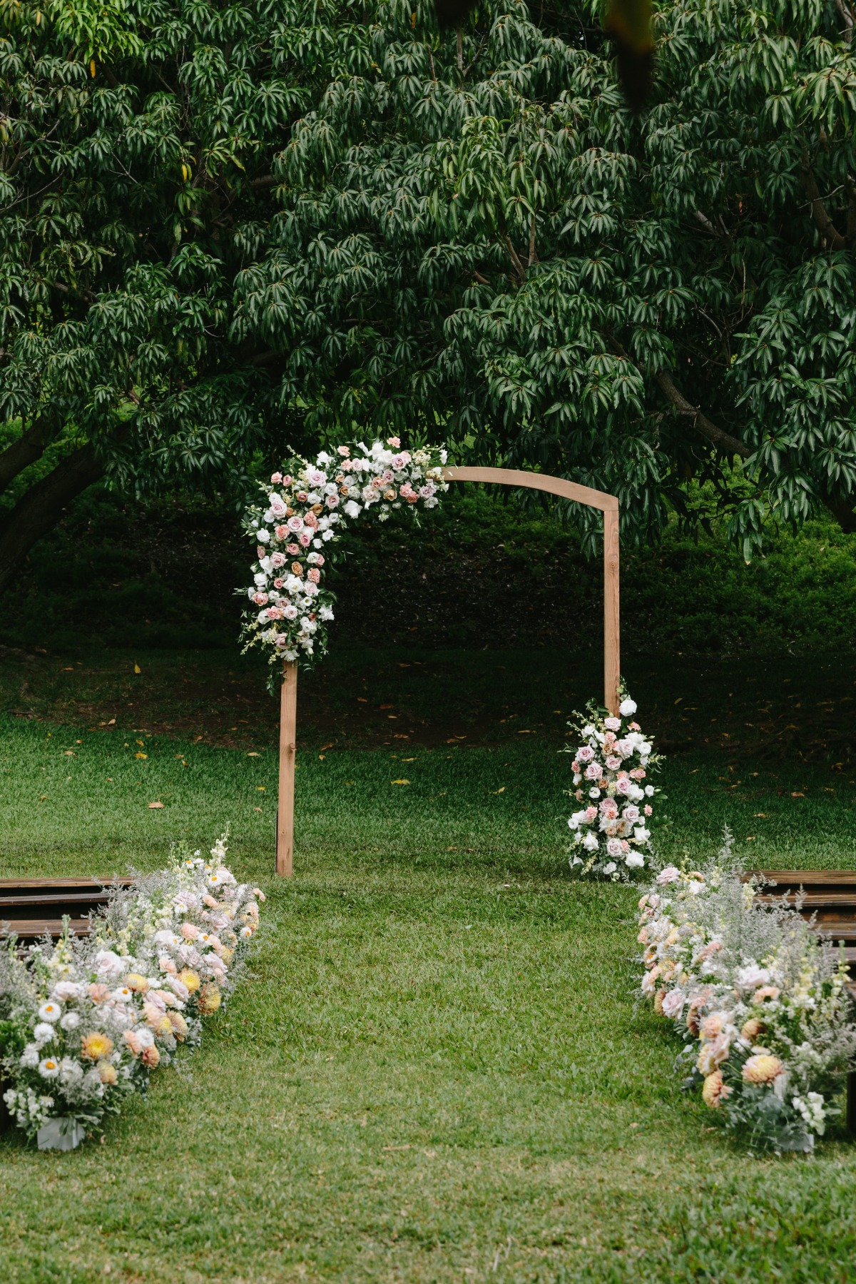 mid century modern wooden arbor with pastel floral arrangements