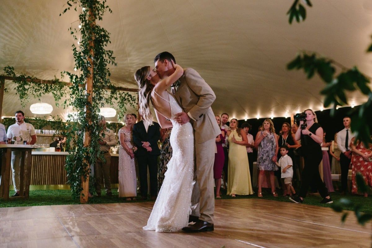 bride and groom dance at tented wedding reception