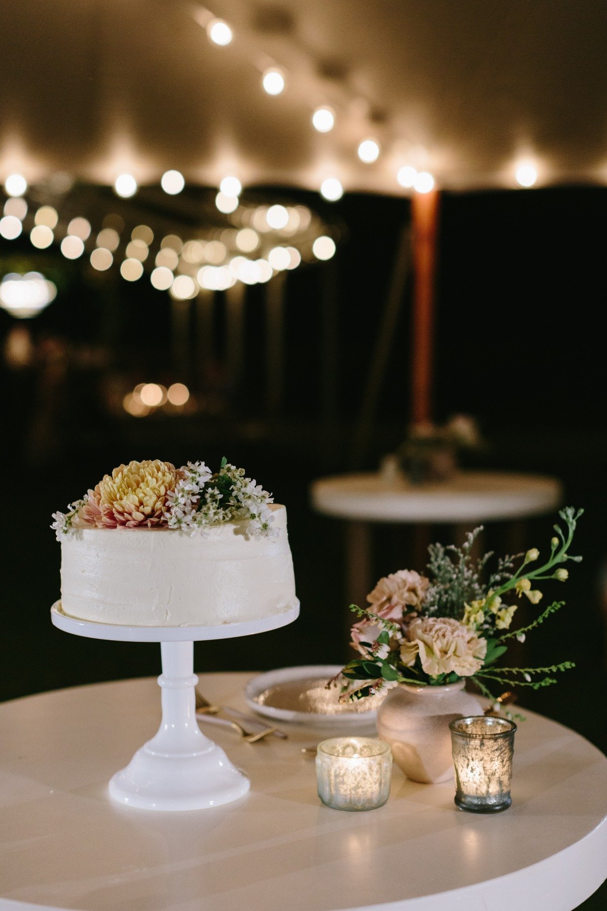 simple butter cream wedding cake with live flowers