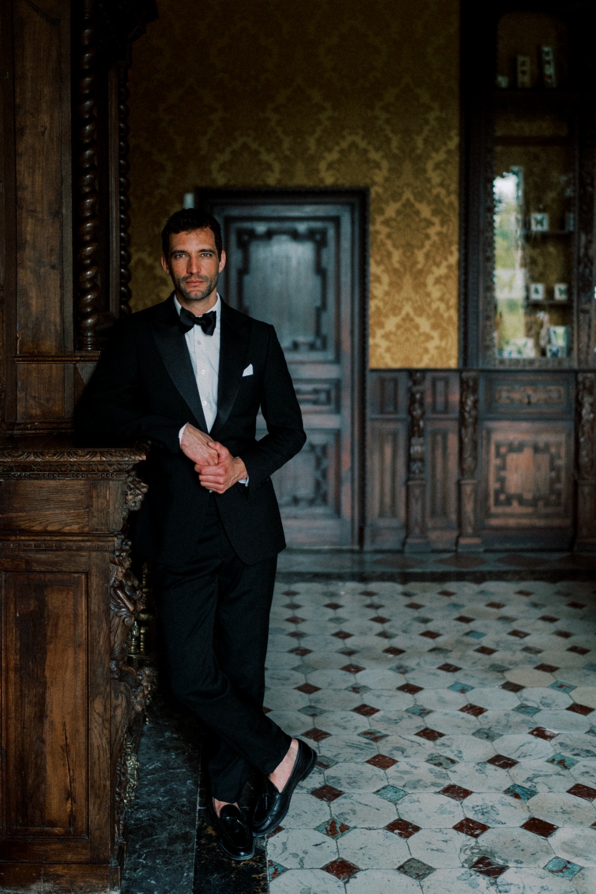 groom in tuxedo in chateau in provence