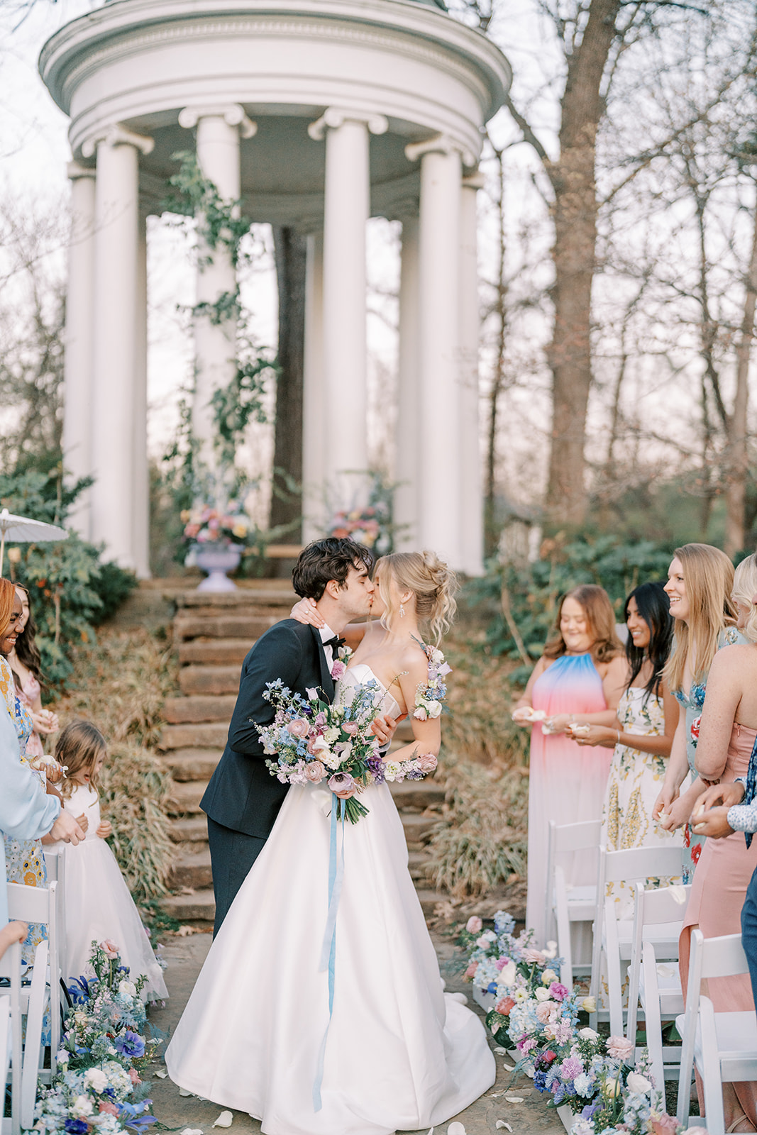 pastel wedding ceremony at a rotunda in a garden