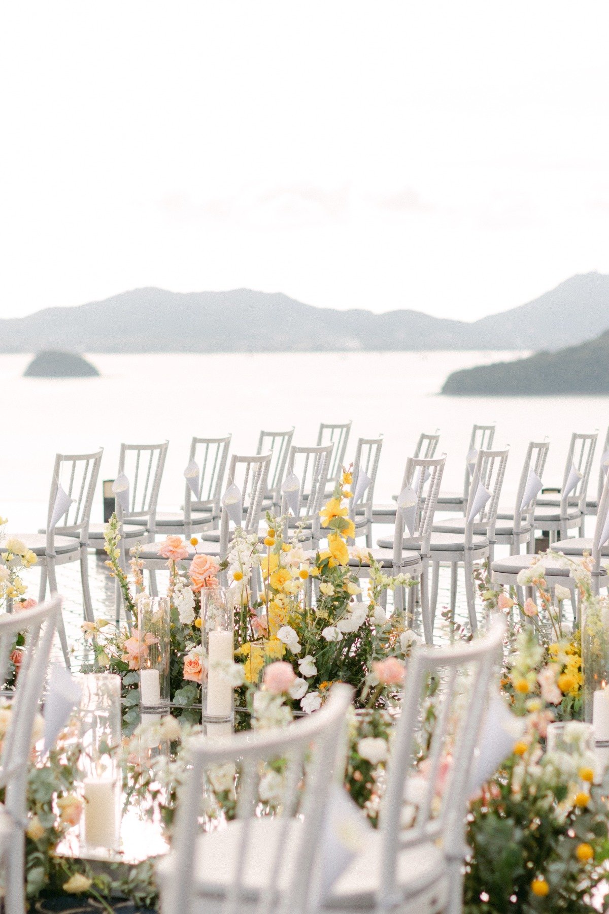 wedding on the water in thailand with mountains in background