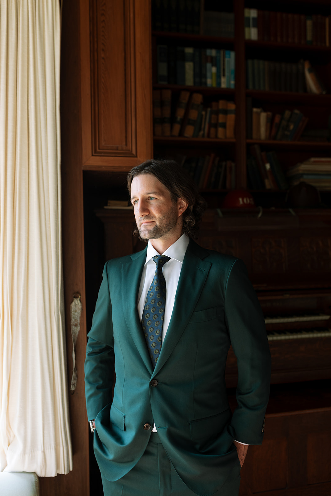 groom in dark green suit