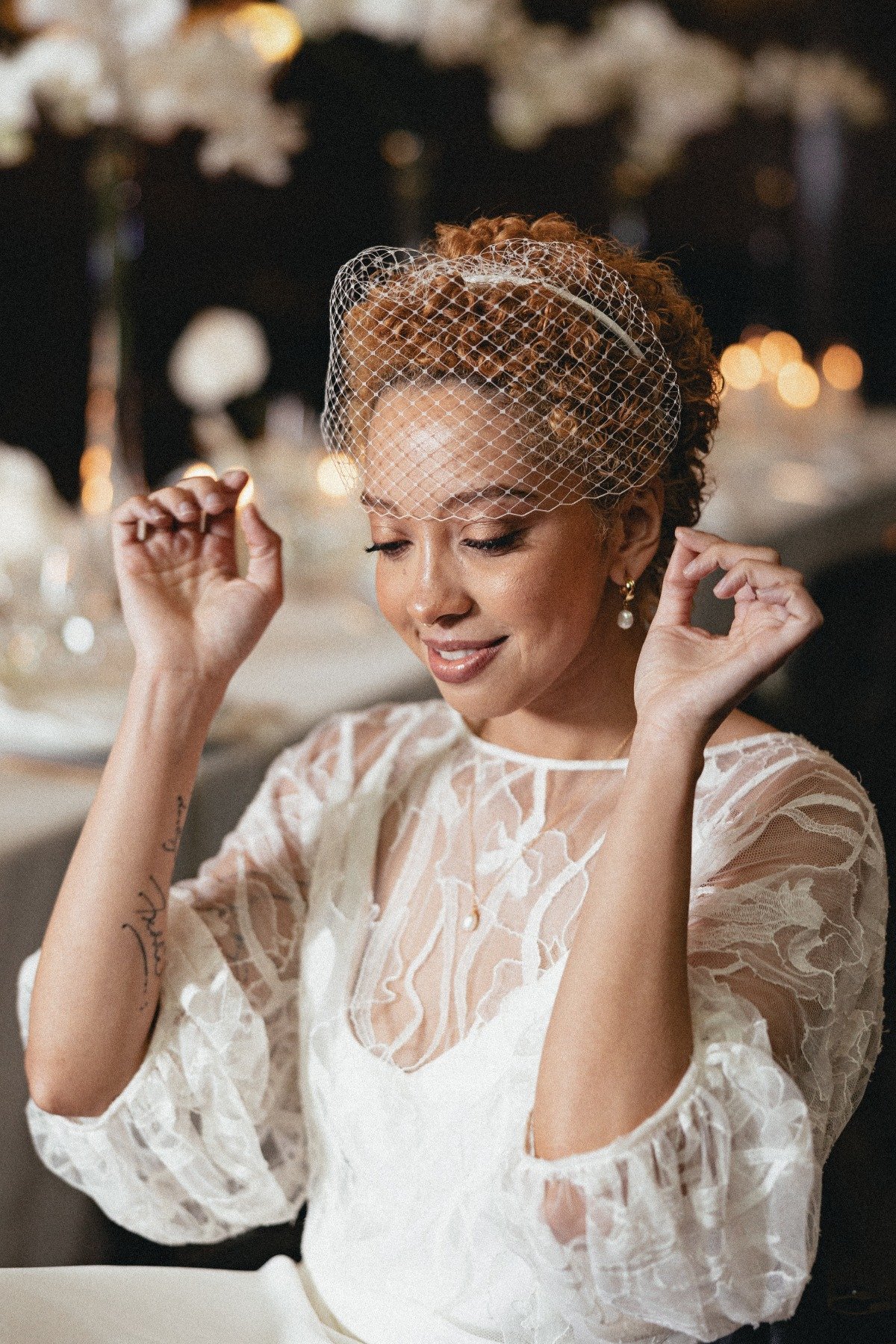 bride in birdcage veil with lace wedding gown