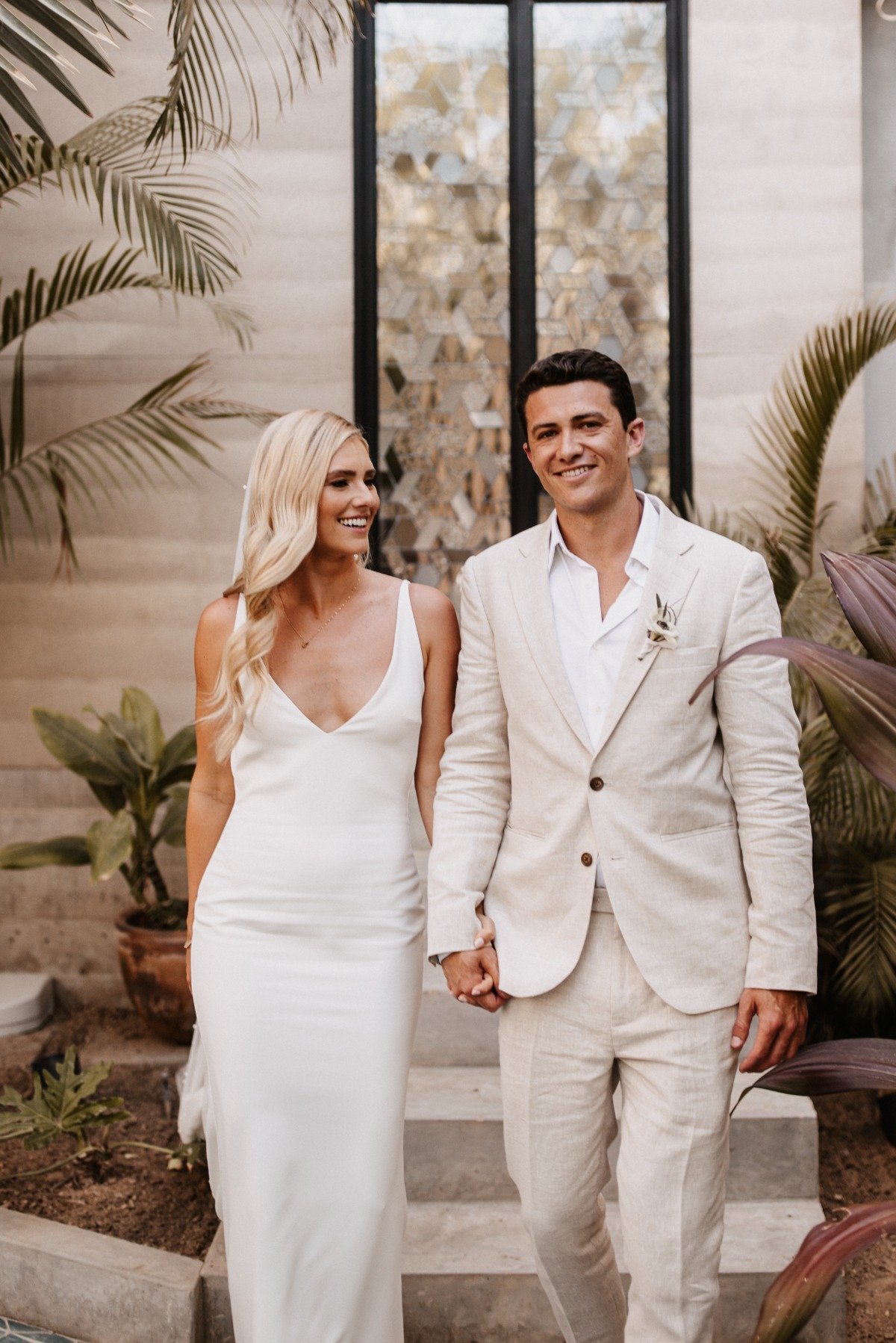 bride in a crepe mermaid gown and groom in tan linen suit