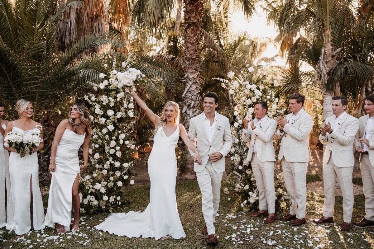 white and tan wedding ceremony with petal toss