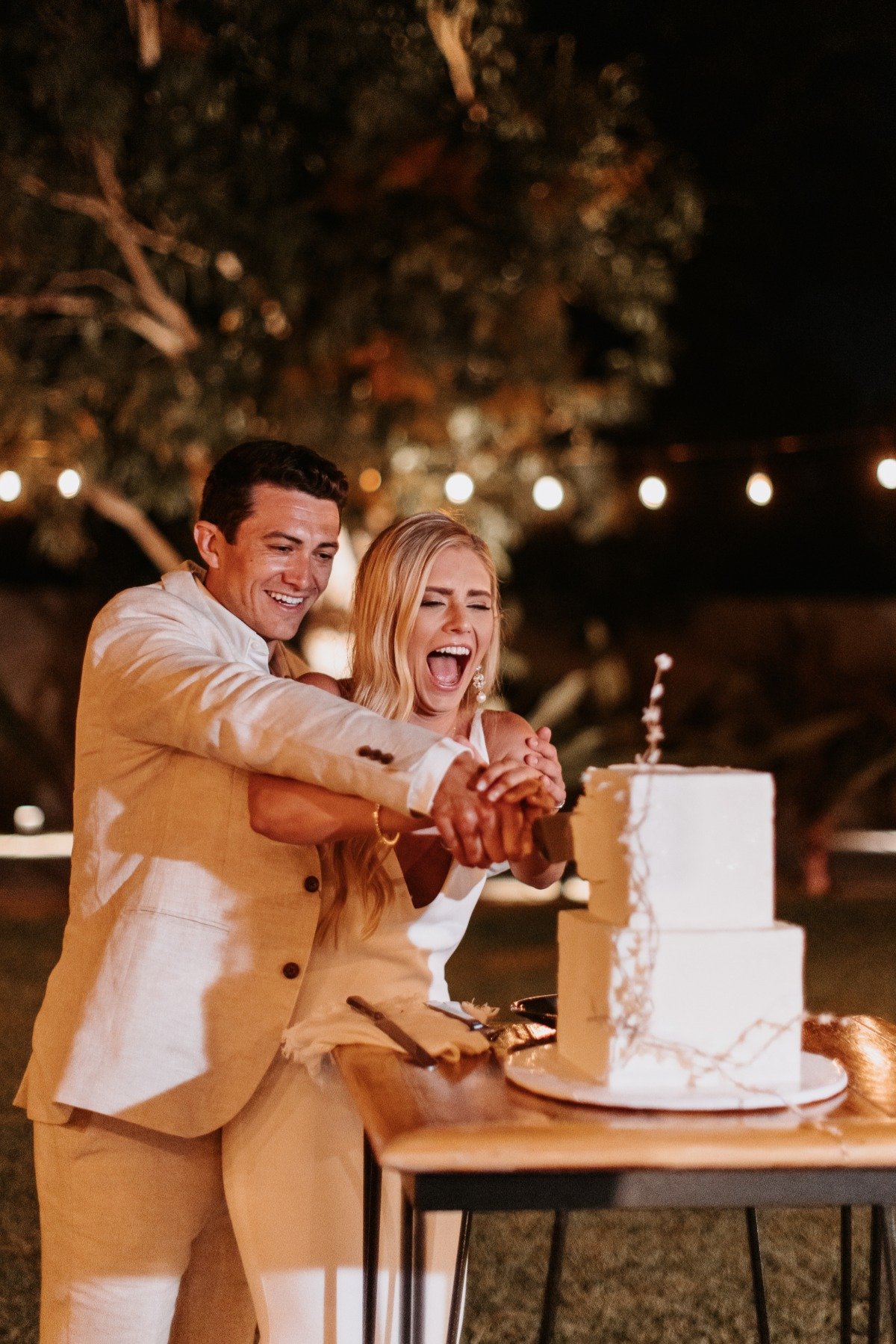 bride and groom cut modern wedding cake