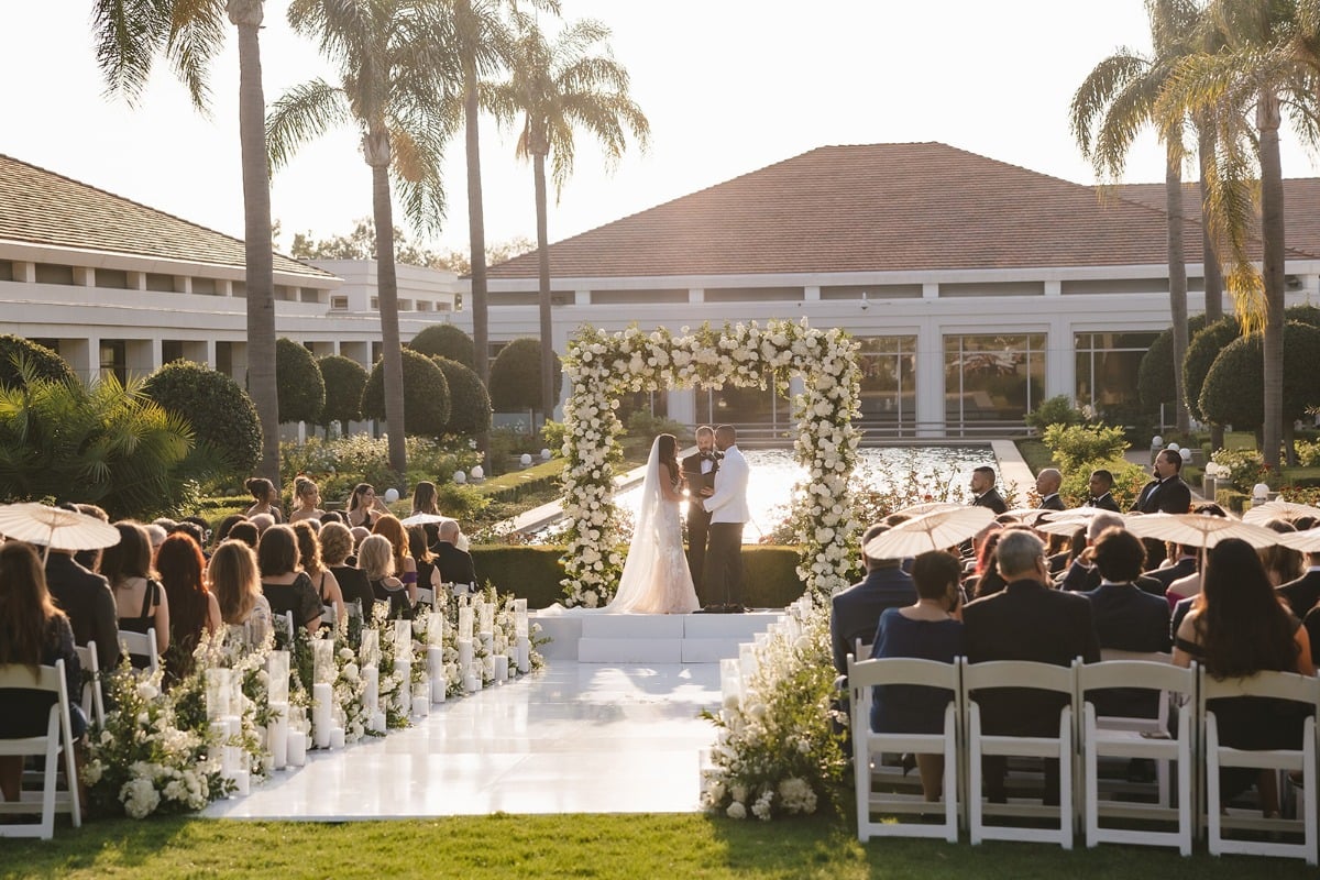 square floral arch with white roses and greenery