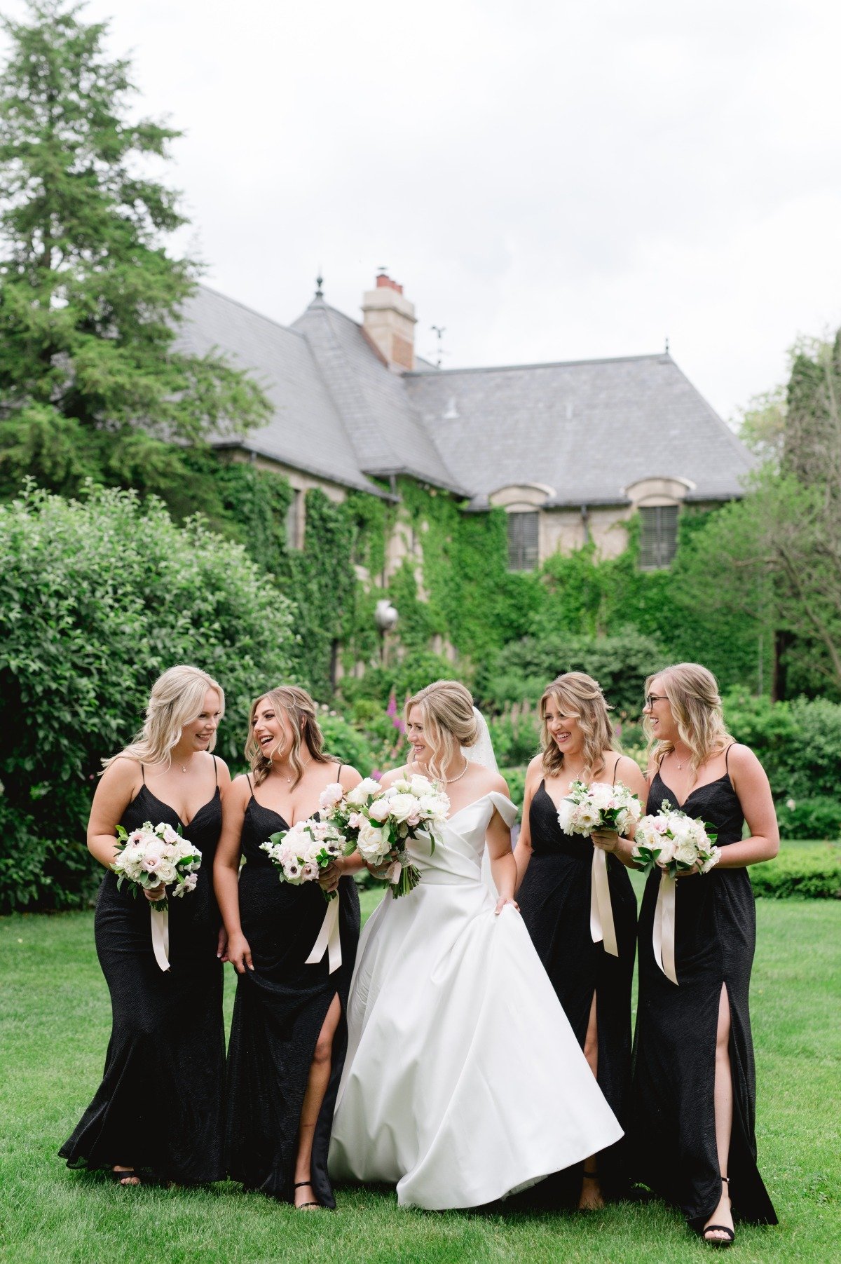 bride in white and bridesmaids in black