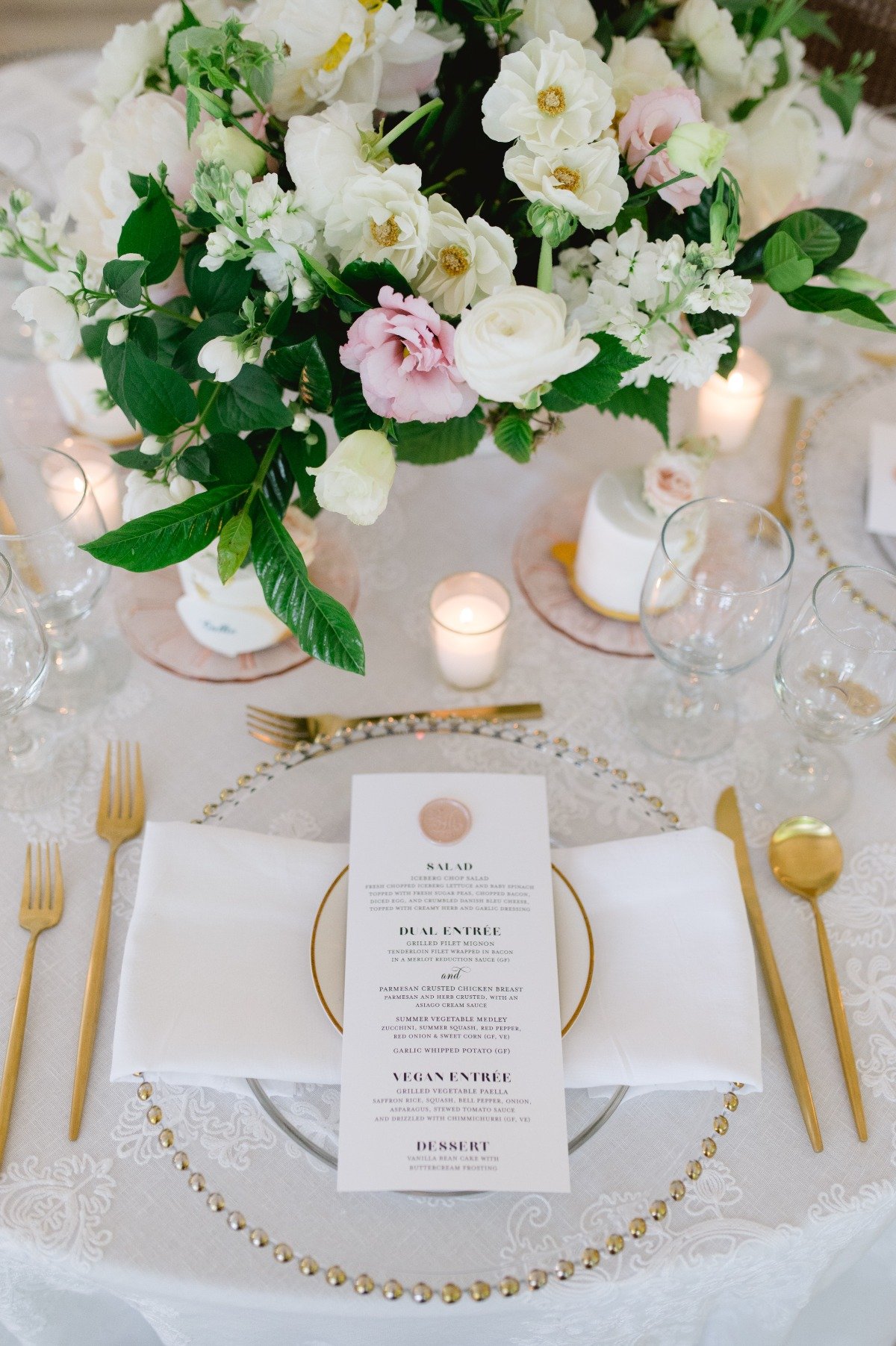 gold charger and silverware at pink and white wedding reception