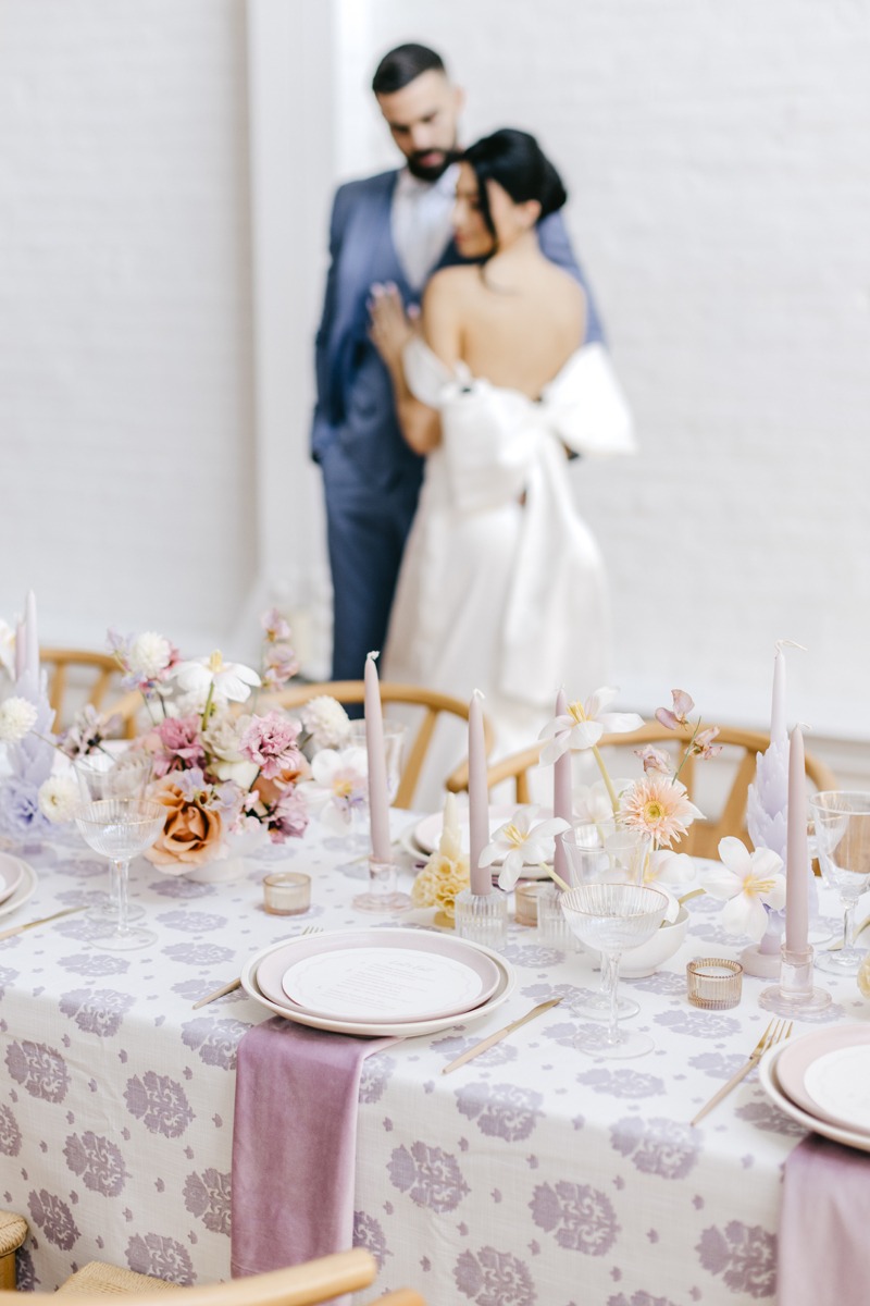 lavender wedding tablescape with pink and peach accents