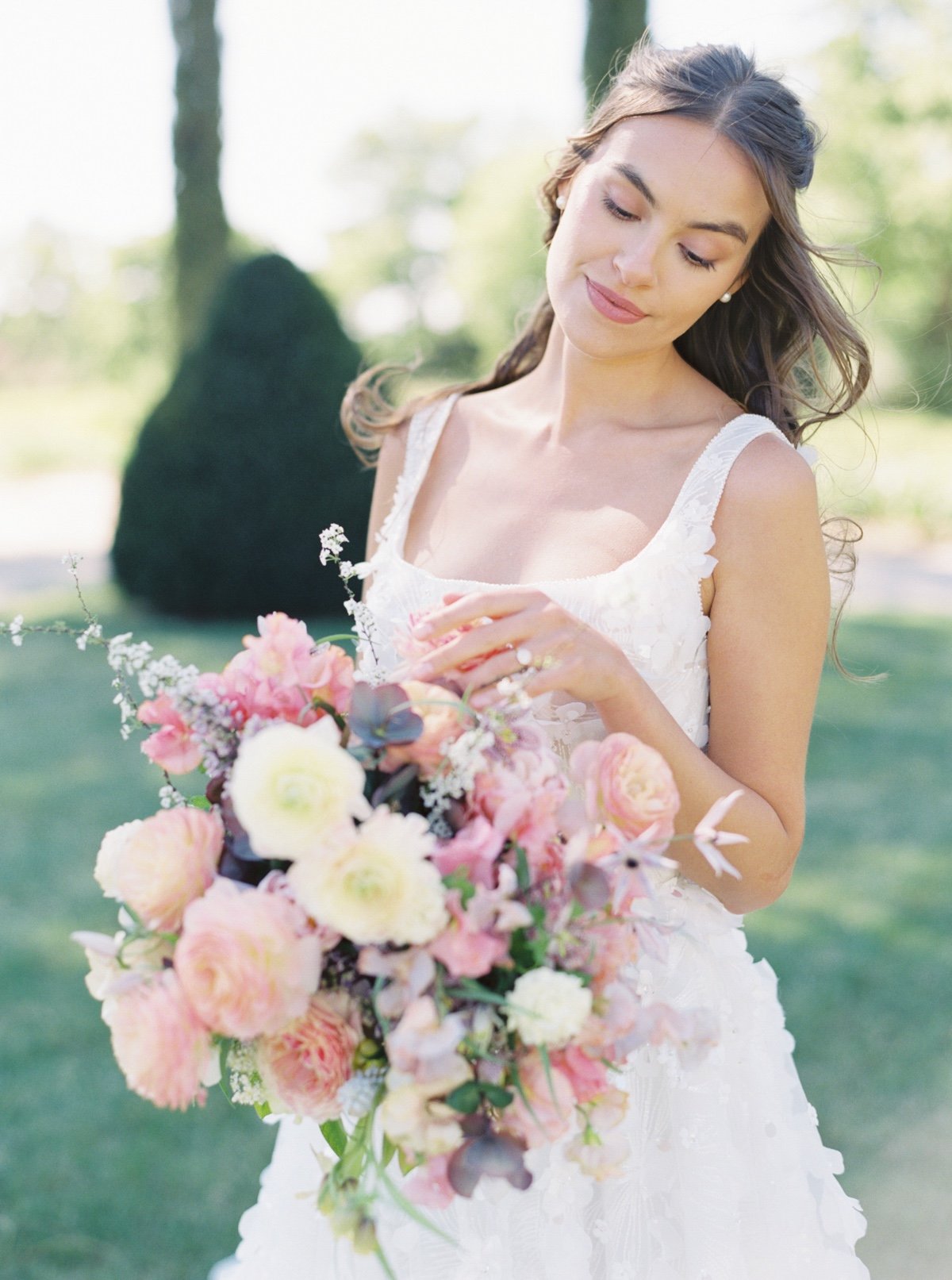 bride at a chateau wedding venue in france with a pastel bouquet