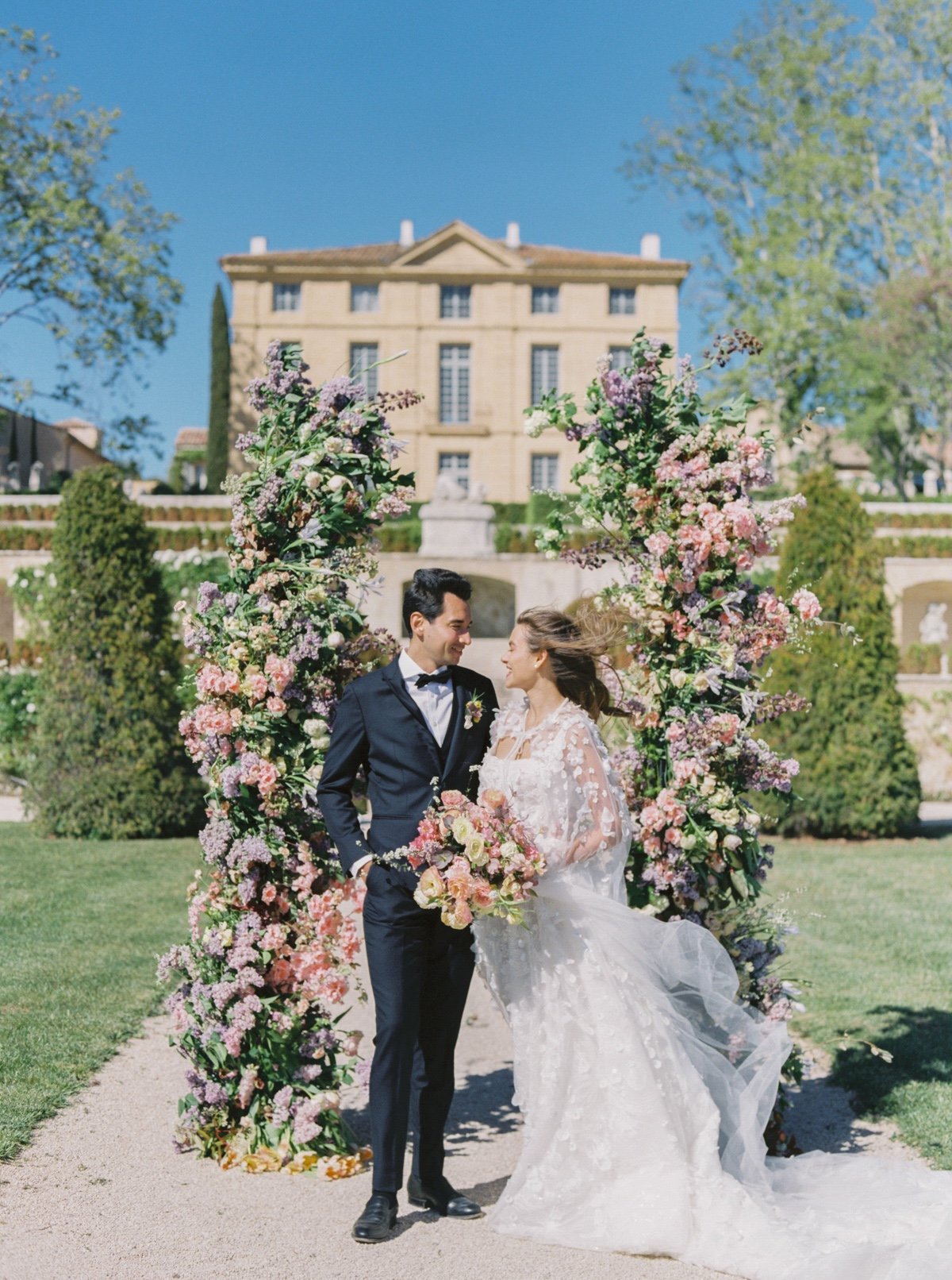 pastel wedding floral arch at a chateau wedding in france