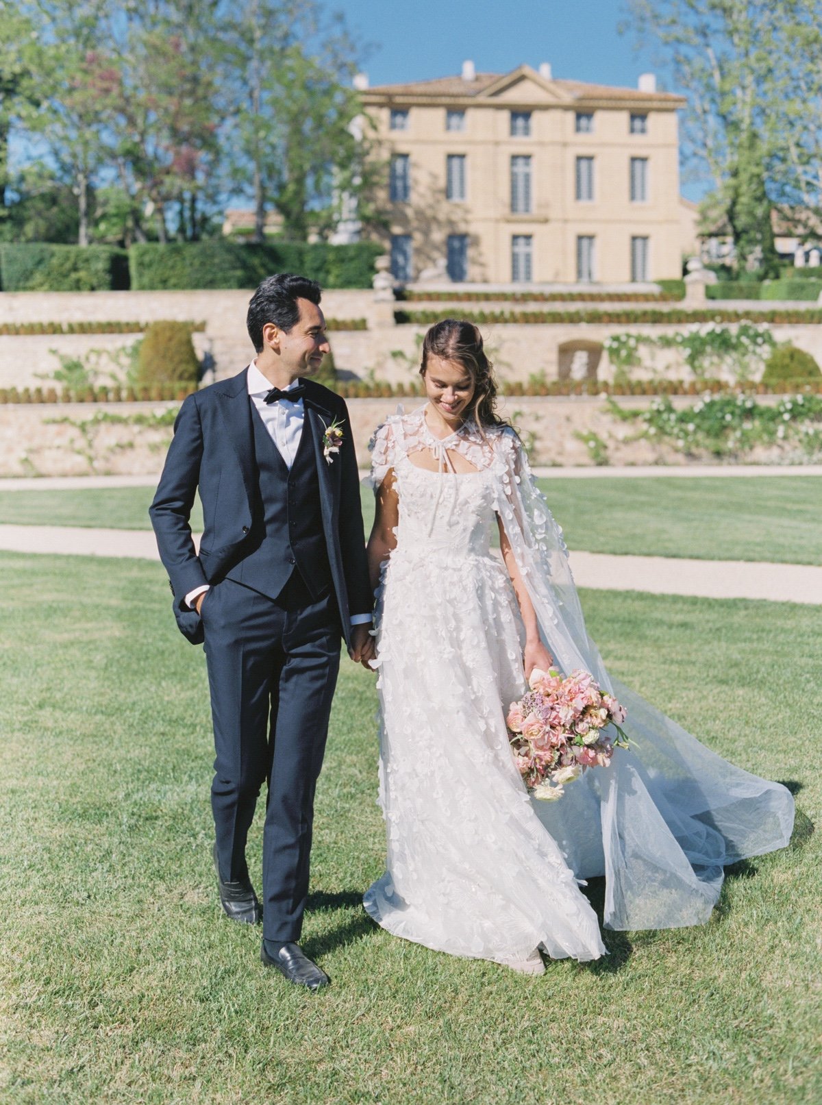 bride in bridal cape with 3D flowers