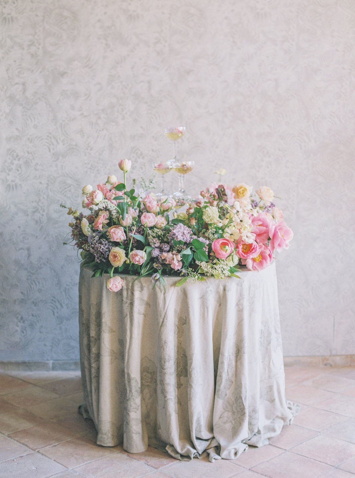 champagne tower with a pastel floral arrangement for wedding