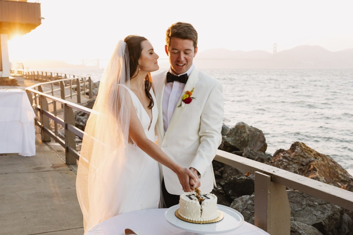 bride and groom cut small white wedding cake