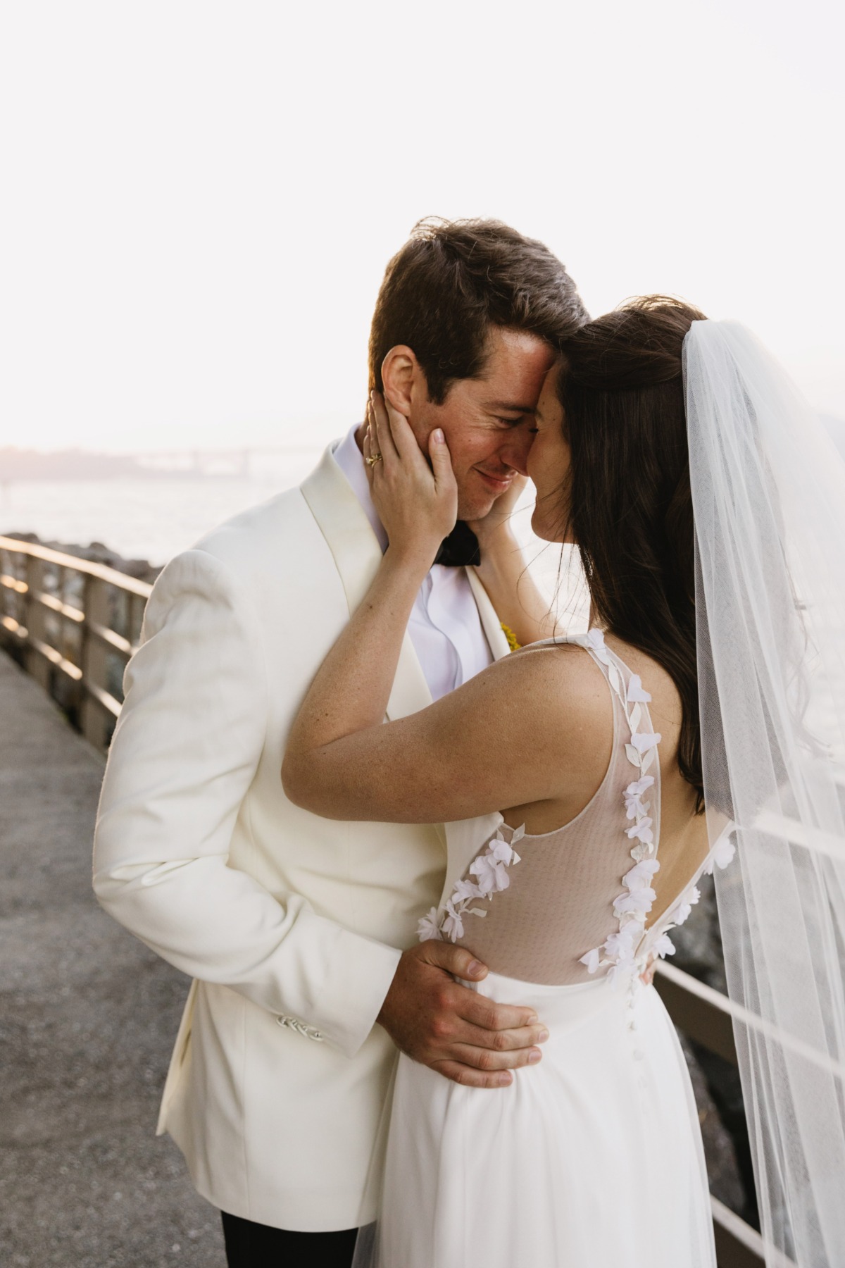 bride and groom in ivory with golden gate bridge in background